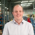 Why is motion system reliability critical for lights-out manufacturing?