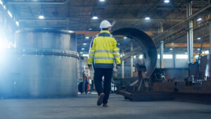 man walking in an industrial environment